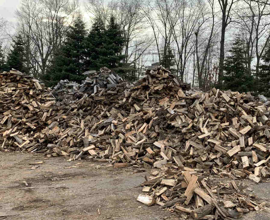 Large pile of dry and aged hard wood for burning